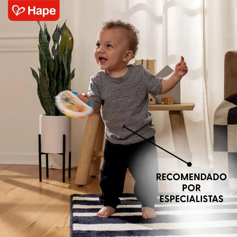 Menino dançando e sacudindo o pandeiro Magic Touch Hape